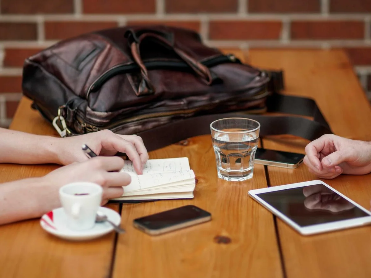 Small notebook with handwritten reset categories, next to a phone showing a timer